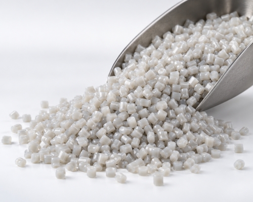 Recycled polypropylene granules held in a metal scoop