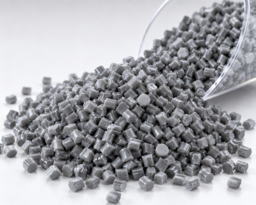 Grey recycled polypropylene granules in a metal scoop